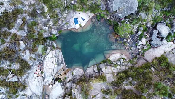 Small blue lagoon created from waterfall in Peneda Geres National Park, Portugal, Europe - drone goi