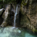 Small waterfall down the mossy rocks falling into a beautiful soca river - PhotoDune Item for Sale