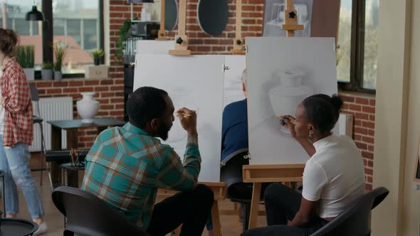 Man and Woman Attending Art Class Lesson to Develop Drawing Skills