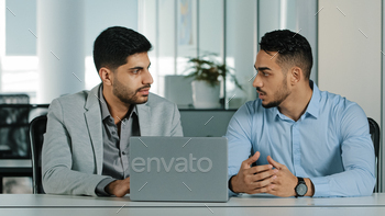 expert talking to indian client customer explain commercial investment deal benefit show computer presentation at bank loan negotiation meeting. High quality photo