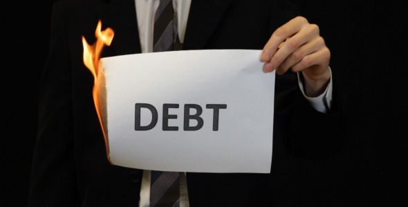 Businessman Burning Debt Sign