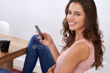  young woman using a cellphone at home