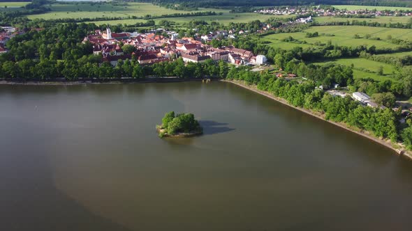 Aerial view of a small historic town Trebon surrounded by a big pond Svet with little island and str