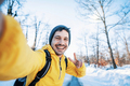 Happy man with backpack taking selfie portrait in winter frosty forest  - PhotoDune Item for Sale