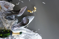 Formal evening wear silver high heels and glittery dress laying on the grey background. - PhotoDune Item for Sale
