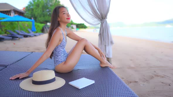 Asian woman enjoy around beautiful beach sea ocean