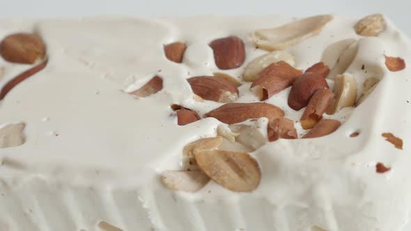 Tasty nougat halva with almonds close-up 4K video