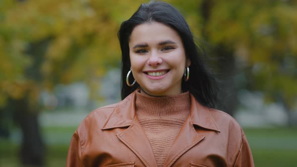 Portrait Young Hispanic Woman Standing Outdoors Smiling Toothy Smile Nodding Shaking Her Head