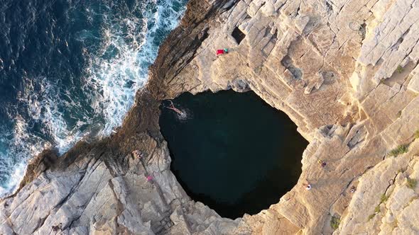 Flying Above a Woman Swimming in a Natural Sea Pool. Giola Lagoon, Thassos Island, Greece, Aerial