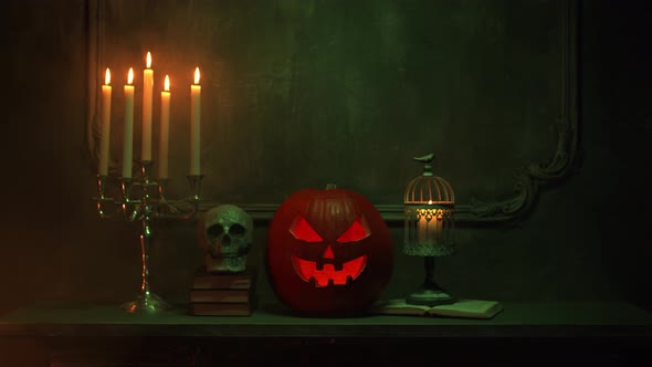 Scary laughing pumpkin and an old skull over the frightening gothic background.