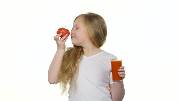 Little Girl Drinks Tomato Juice and Licks Her Lips, White Background