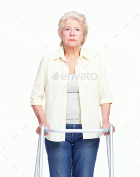 Portrait of a serious elderly woman holding her zimmer frame while isolated on white