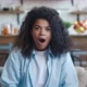 Close Up Portrait of Young African American Woman with Wow Expression While Sitting on Sofa at Home - VideoHive Item for Sale
