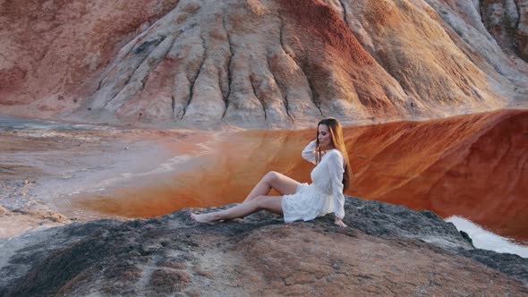 Beautiful woman posing on other-worldly hilly landscape