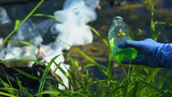 Person Pouring Biohazard Liquid in Polluted Water, Toxic Waste, Spreading Virus