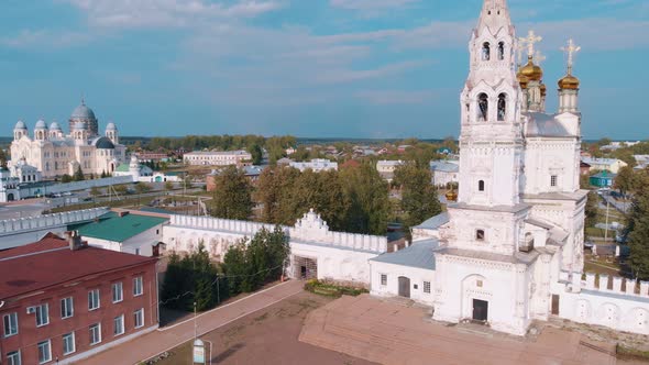 Flight of a Drone Over an Orthodox or Christian Cathedral and a Kremlin with Golden Domes and a Bell