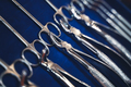 row of various dental tools on display on blue background with shallow depth of field - PhotoDune Item for Sale