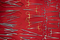 medical scissors and other basic stainless steel dental tools supplies on red fabric background - PhotoDune Item for Sale