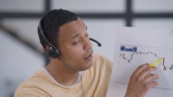 Portrait of Confident Young African American Manager Greeting Waving in Video Chat Talking Pointing