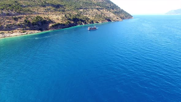 Tour boat next to mountains in Albania