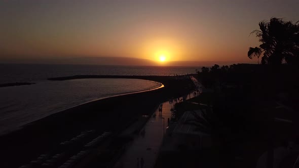 Flying Along the Promenade of Los Cristianos at Dusk Canary Islands Tenerife Spain