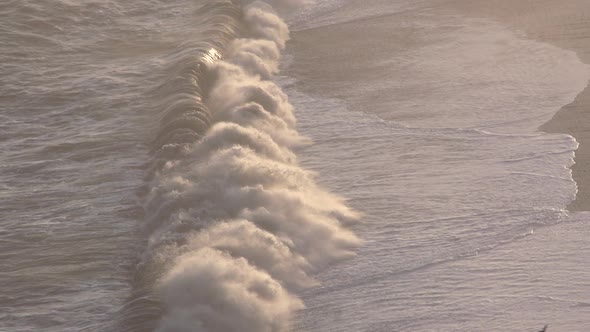 Waves breaking on sunset shore