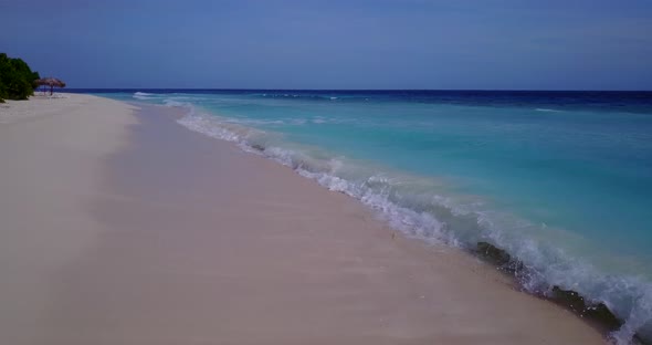 Luxury drone clean view of a white sand paradise beach and blue ocean background in vibrant 4K