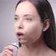 Young Woman Cleaning Teeth with Water Flosser and Smiling - VideoHive Item for Sale