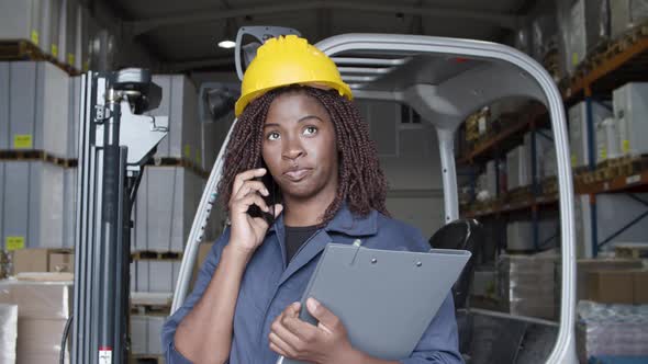 African American Female Worker Talking on Phone