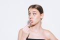 Beauty portrait of girl with fresh skin, teenager doing lips makeup on white background isolated - PhotoDune Item for Sale