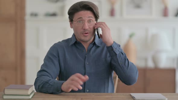 Man Talking on Phone in Office