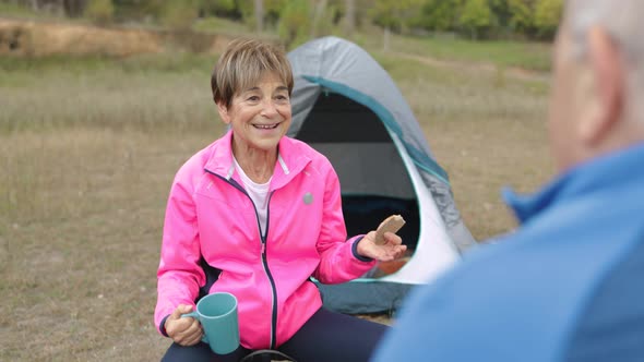 Happy Senior Couple Having Fun Eating and Drinking While Camping Outdoor in the Woods Elderly Travel
