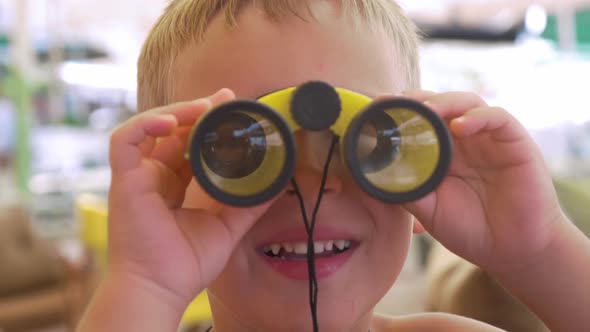 Child Looking Through the Binoculars