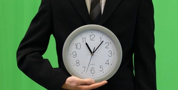 Businessman Shows Time on Clock (green)