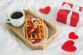 Breakfast for valentines Day. Wooden tray with belgian waffle and cup of coffee on white bed linen. - PhotoDune Item for Sale