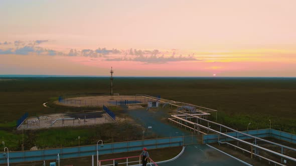 The Drone Captures the Decline of the Oil and Gas Industry the Drone Descends to the Worker Who