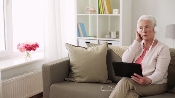 Senior Woman with Tablet Pc and Headphones at Home 