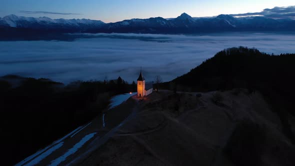 Church of St. Primoz and Felicijan in the Morning. Jamnik, Slovenia. Aerial View