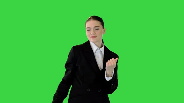 Young Woman in Office Suit Dances Waving Her Arms on a Green Screen Chroma Key