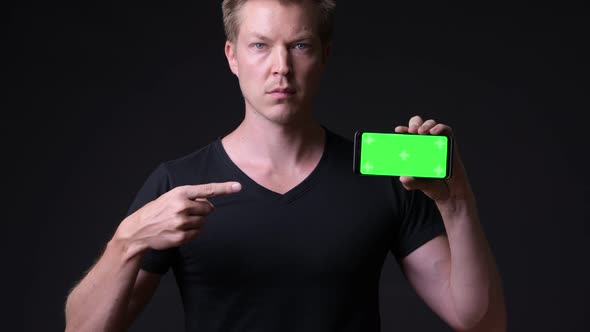 Young Handsome Man Using Mobile Phone with Green Screen Chroma Key