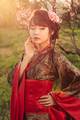 Portrait of beautiful asian woman in blooming park at sunset - PhotoDune Item for Sale