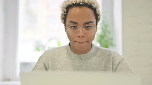 Close Up of African Woman Having Headache While Using Laptop