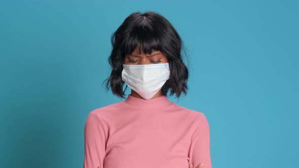 Worried Dark Skinned Young Woman Wears Protective Face Mask To Stop Virus
