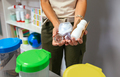 Female teacher holding waste to recycle with selective trash bins in foreground - PhotoDune Item for Sale