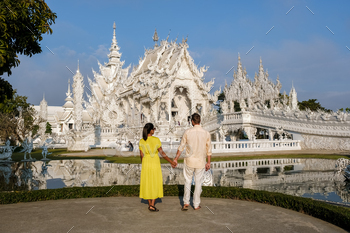 nd, Wat Rong Khun, aka The White Temple, in Chiang Rai, Thailand. Asian women and Caucasian men visit a temple