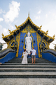 couple visit the Rong Sua Ten temple blue temple , Chiang Rai Province, Thailand - PhotoDune Item for Sale
