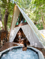 couple man and woman in tent with jaccuzzi in the jungle rain forest, luxury glamping - PhotoDune Item for Sale