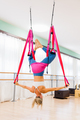 Athletic woman doing aerial yoga inverted pigeon pose - PhotoDune Item for Sale