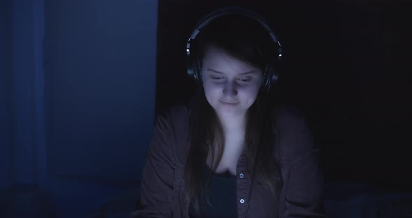 Woman listens music in headphones