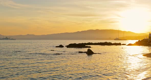 Sunset on the French Coast in Cannes Huge Yachts are on the Horizon Still Water